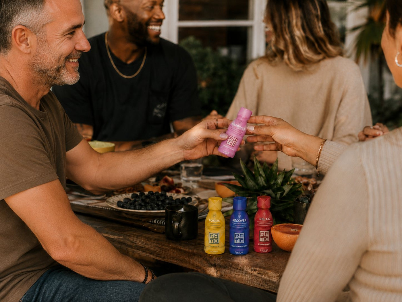 Friends sharing Ratio shots around a table